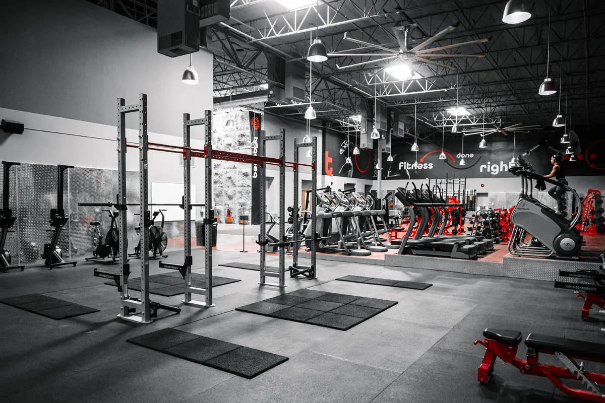 Squat racks and lifting platforms beside the cardio deck at Teqneeq Functional Health Center in 4S Ranch, San Diego